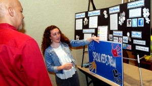 Madeline O'Neill explains her winning project to judge Cory Laws at the 2014 Step Up Loudoun Youth Competition