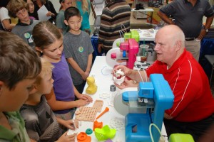 YouthQuest Director of Instruction Tom Meeks talks to children about 3D printing at a STEM career fair in Dulles, Va. 