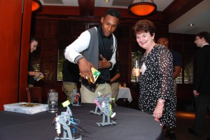 3D ThinkLink Lab student Daikwon Jones explains his solar robot to Joy Gilstrap at YouthQuest's VIP Reception Aug. 7, 2014