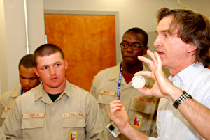 Michael Foster listens to Dr. David Rocheleau explain how a 3D printing is used at the University of South Carolina Department of Mechanical Engineering.