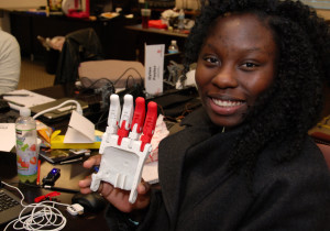 3D ThinkLink Lab student Sherquana Adams from South Carolina Youth ChalleNGe Academy holds a partially assembled 3D-printed robohand