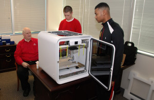 YouthQuest Director of Instruction Tom Meeks  sets up a new CubePro 3D printer with 3DThinkLink Lab students Caleb Dujmovic and Christopher Coleman.