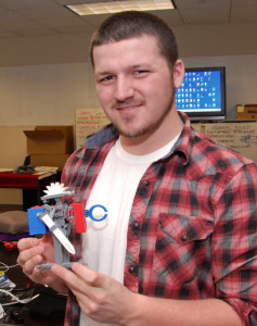 3D ThinkLInk Lasb student Dylan Foster from South Carolina Youth ChalleNGe Academy holds his walking robot