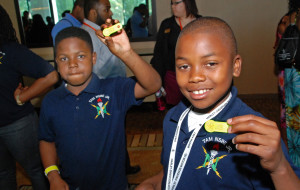 Students show the 3D-printed tags they created in YouthQuest's workshop at the National Society of Black Engineers Convention in Anaheim March 27, 2015.