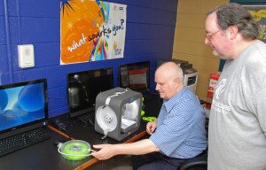 Tom Meeks (left) and Chris Roberts set up equipment for 3D ThinkLink classes at Culmore Club