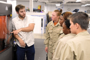 Duncan-Parnell's Camren Summerlin shows students a 3D-printer