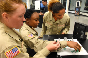 South Carolina Youth ChalleNGE Academy 3D ThinkLink students Hailey Key, Asia Grant and Alycia Freeman examine 3D printed objects during Vocational Orientation at 3D Systems in Rock Hill, South Carolina on April 21, 2016