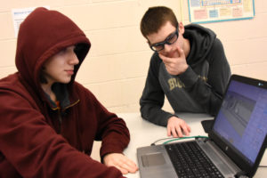 Luke McHugh, left, and Adam Eldert work on a 3D design in YouthQiest's 3D ThinkLink class at the PHILLIPS School in Annandale, Virginia