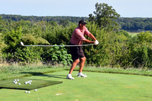 Brad Denton swings his 10-foot driver during a trick shot demonstration before the Challenge at Trump National Golf Club August 8, 2016