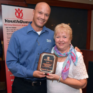 YouthQuest Co-Founder and President Lynda Mann presents the 2016 Community Partner Award to Duncan-Parnell’s Joe Holmberg on August 4.
