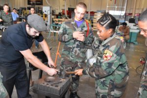 Aunya Jones and Brock Jasmann try blacksmithing during Vocational Orientation at The Foundery in Baltimore