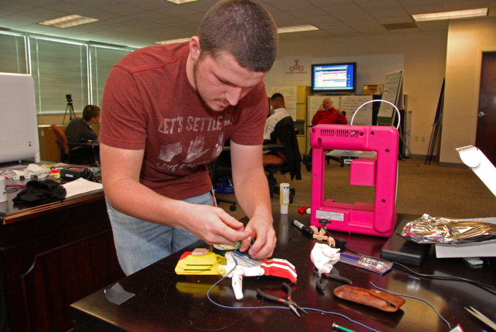 South Carolina Youth ChalleNGe Academy graduate Dylan Foster assembles a 3D-printed prosthetic hand during advanced training in YouthQuest's 3D ThinkLink Creativity Lab on January 8, 2015 in Chantilly, Virginia.