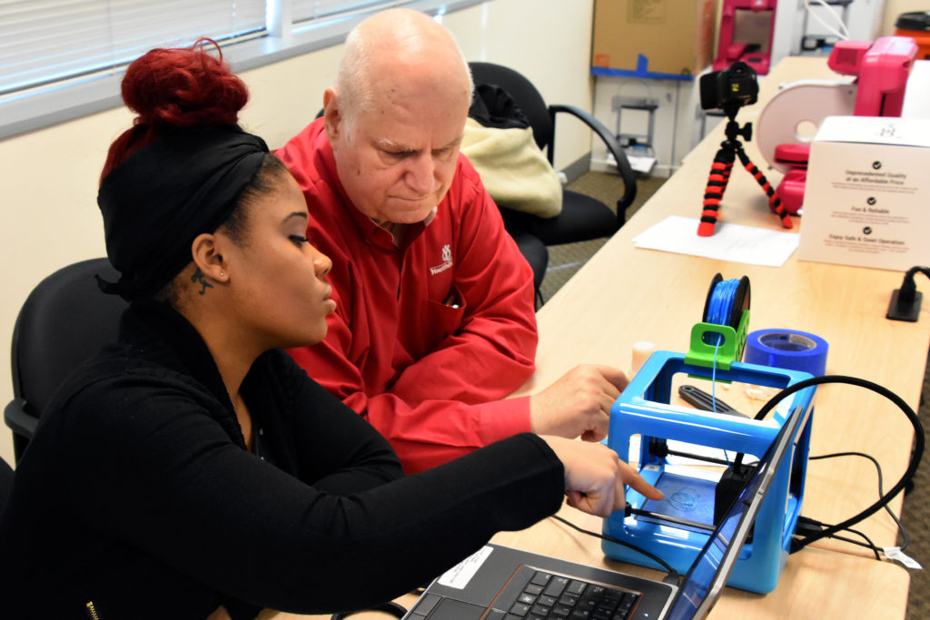 Freestate ChalleNGe Academy graduate Aunya' Jones and YouthQuest Director of Instruction Tom Meeks work on setting up a 3D printer during Youth Mentor training in the 3D ThinkLink Creativity Lab on January 11, 2017 in Chantilly, Virginia.