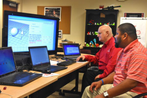 YouthQuest Director of Instruction, Tom Meeks. show Moment of Inspiration 3D design software to Jonathan Brown from Maryland's Freestate ChalleNGe Academy during 3D ThinkLink Teacher Training Week in September, 2017.