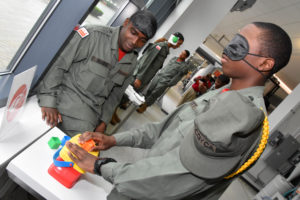 3D ThinkLink students from Capital Guardian Youth ChalleNGe academy do hands-on activities to simulate various disabilities during a Vocational Orientation tour of Local Motors National Harbor on April 19, 2018.