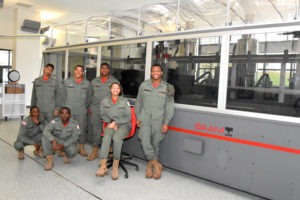 3D ThinkLink students from Capital Guardian Youth ChalleNGe Academy pose next to the BAAM, a giant 3D printer used to make Local Motors' Accessible Olli self-driving shuttle