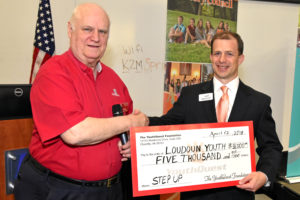YouthQuest Director of Instruction Tom Meeks presents the Step Up prize money check to Loudoun Youth CEO Jared Melvin on April 12, 2018