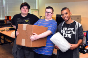 Henry, John and Ladrious with box of 3D printed artifact replicas to ship to Vancouver iTech Prep